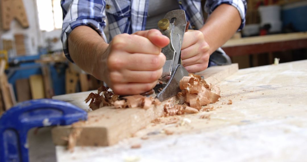 Carpenter Shaping Wood with Hand Plane in Workshop - Free Images, Stock Photos and Pictures on Pikwizard.com