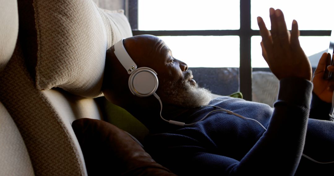 Bearded Man Relaxing with Headphones and Smartphone - Free Images, Stock Photos and Pictures on Pikwizard.com