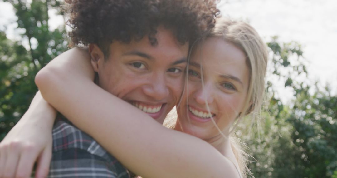 Happy Diverse Couple Embracing in Sunny Garden