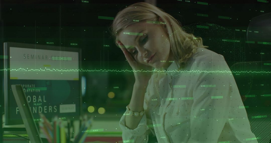 Woman Analyzing Data on Laptop during Late Night in Office