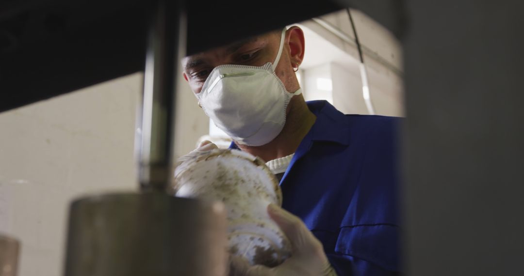 Worker Wearing Mask and Inspecting Industrial Equipment in Factory - Free Images, Stock Photos and Pictures on Pikwizard.com