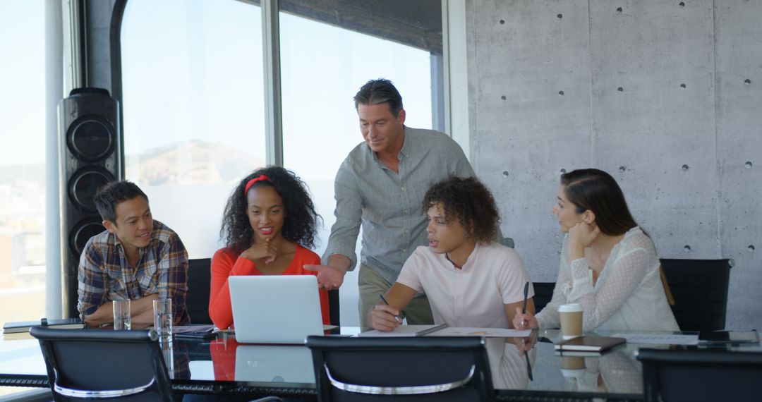 Diverse Business Team Collaborating on Project Together in Modern Office