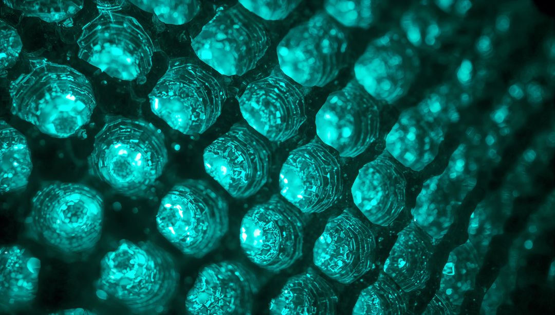 Teal Faceted Lens Array Emitting Glowing LED Light, Honeycomb Optics Macro Abstract