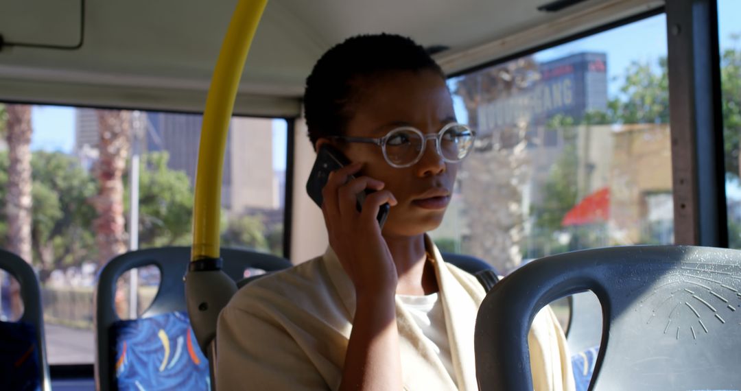 Focused Young Woman Talking on Smartphone During Bus Ride - Free Images, Stock Photos and Pictures on Pikwizard.com