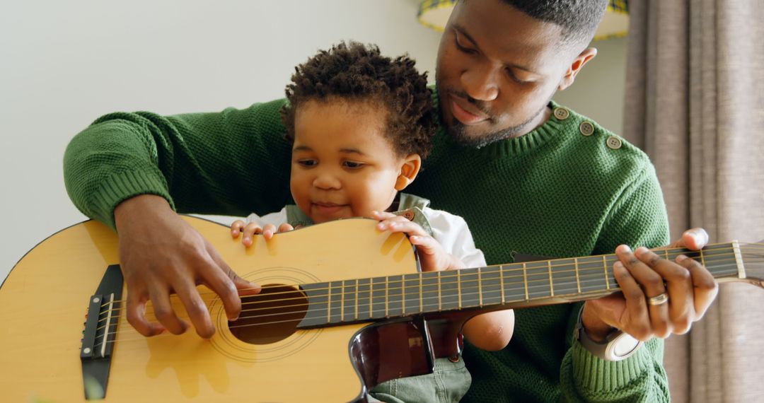 Father Teaching Young Son How to Play Guitar at Home - Free Images, Stock Photos and Pictures on Pikwizard.com