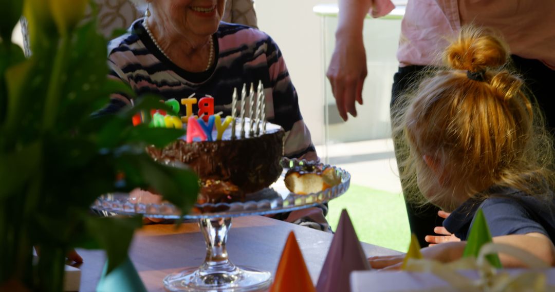 Joyful Family Birthday Celebration with Grandmother and Granddaughter - Free Images, Stock Photos and Pictures on Pikwizard.com