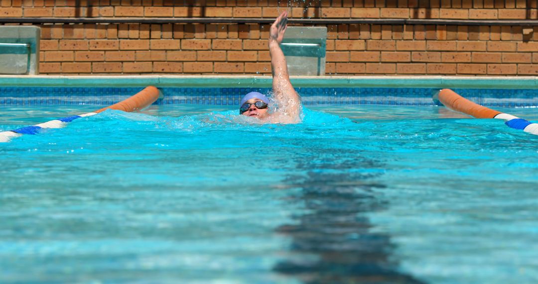 Focused Swimmer Practicing Backstroke in Outdoor Pool - Free Images, Stock Photos and Pictures on Pikwizard.com