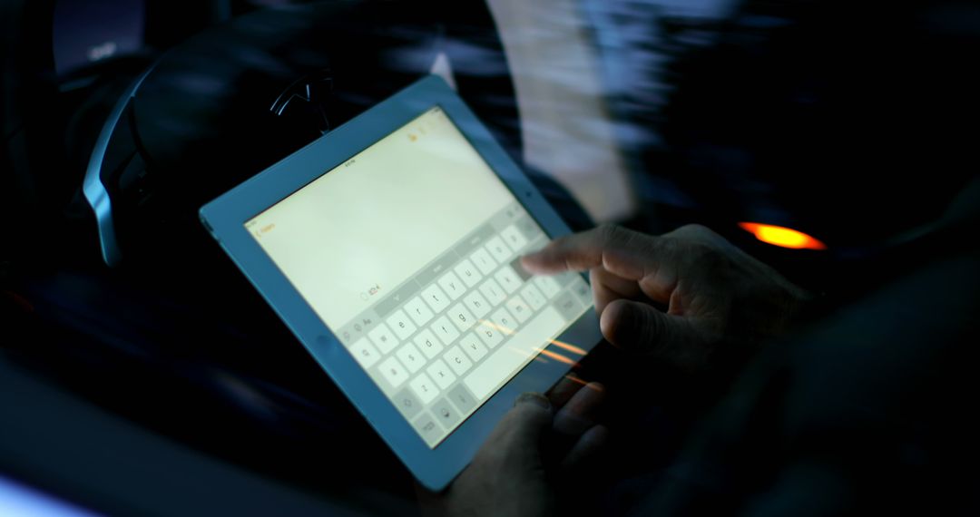 Person Using Tablet with Digital Keyboard in Dimly Lit Environment - Free Images, Stock Photos and Pictures on Pikwizard.com