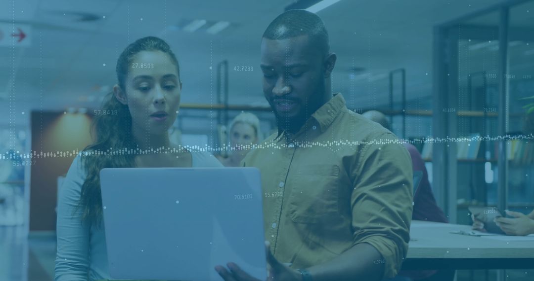 Diverse Business Team Reviewing Financial Data on Laptop