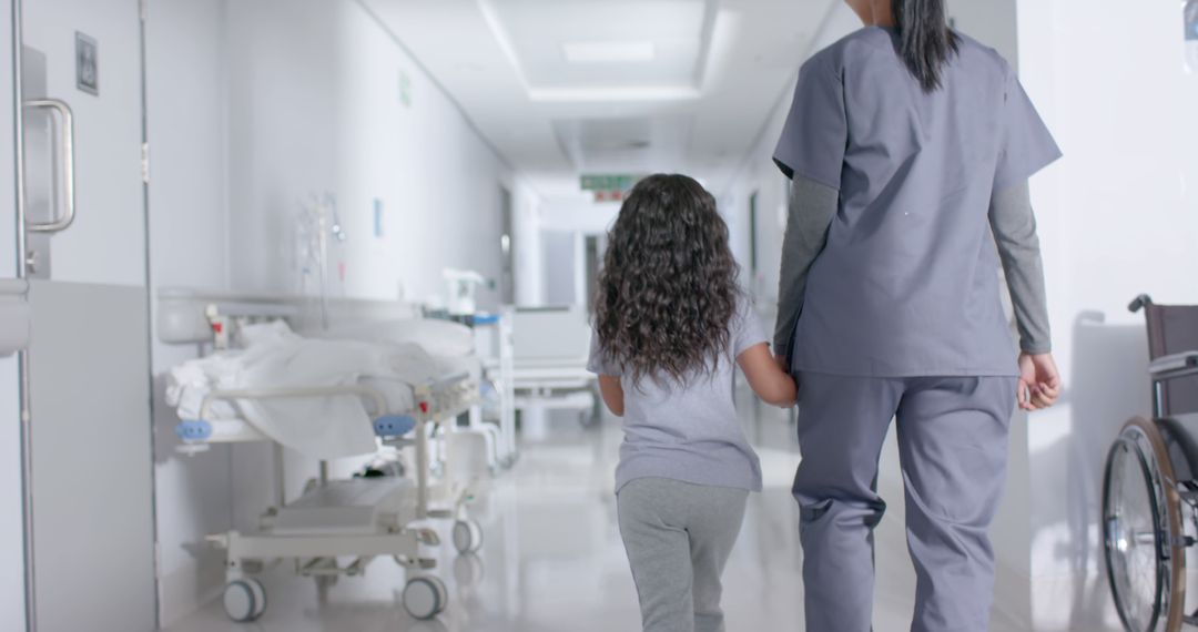 Nurse Guiding Child Through Hospital Hallway - Free Images, Stock Photos and Pictures on Pikwizard.com