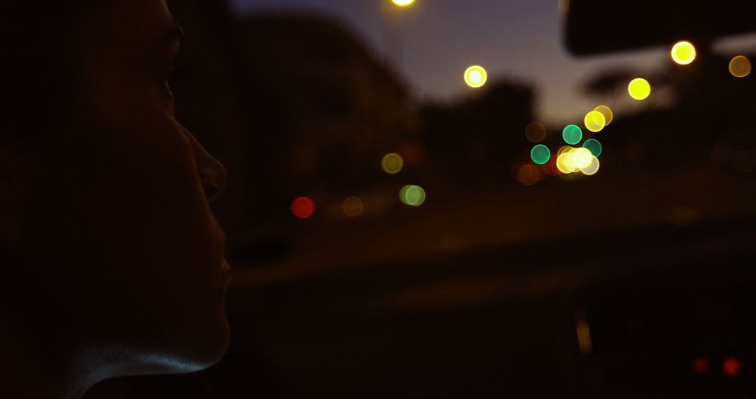 Person Driving Car at Night with Blurred City Lights - Free Images, Stock Photos and Pictures on Pikwizard.com