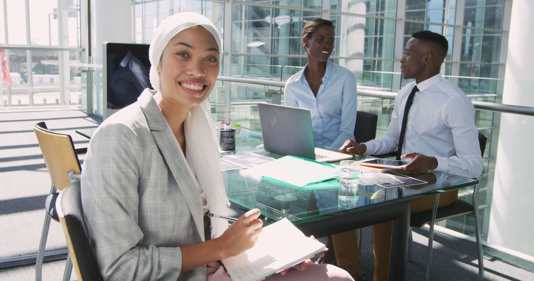 Smiling Biracial Businesswoman Holding Notebook in Office with Copy Space - Free Images, Stock Photos and Pictures on Pikwizard.com