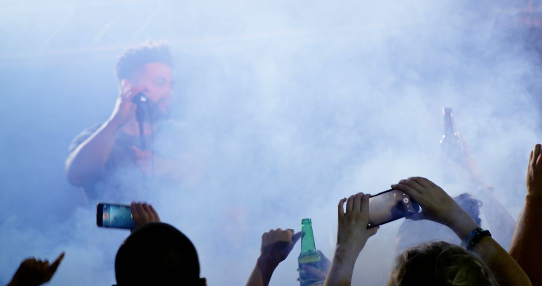 Dynamic Concert Atmosphere with Smartphones and Smoke Effects - Free Images, Stock Photos and Pictures on Pikwizard.com