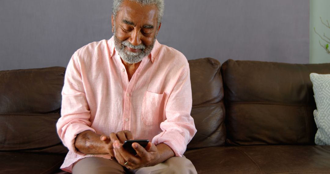 Senior Man Using Smartphone While Relaxing on Couch - Free Images, Stock Photos and Pictures on Pikwizard.com