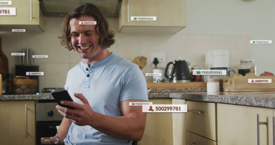 Man Using Smartphone in Modern Kitchen with Social Media Tags - Free Images, Stock Photos and Pictures on Pikwizard.com