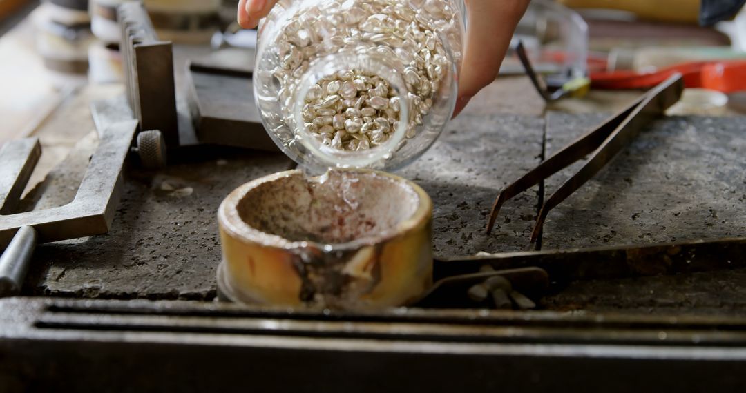 Jeweler Pouring Silver Granules into Furnace for Melting - Free Images, Stock Photos and Pictures on Pikwizard.com