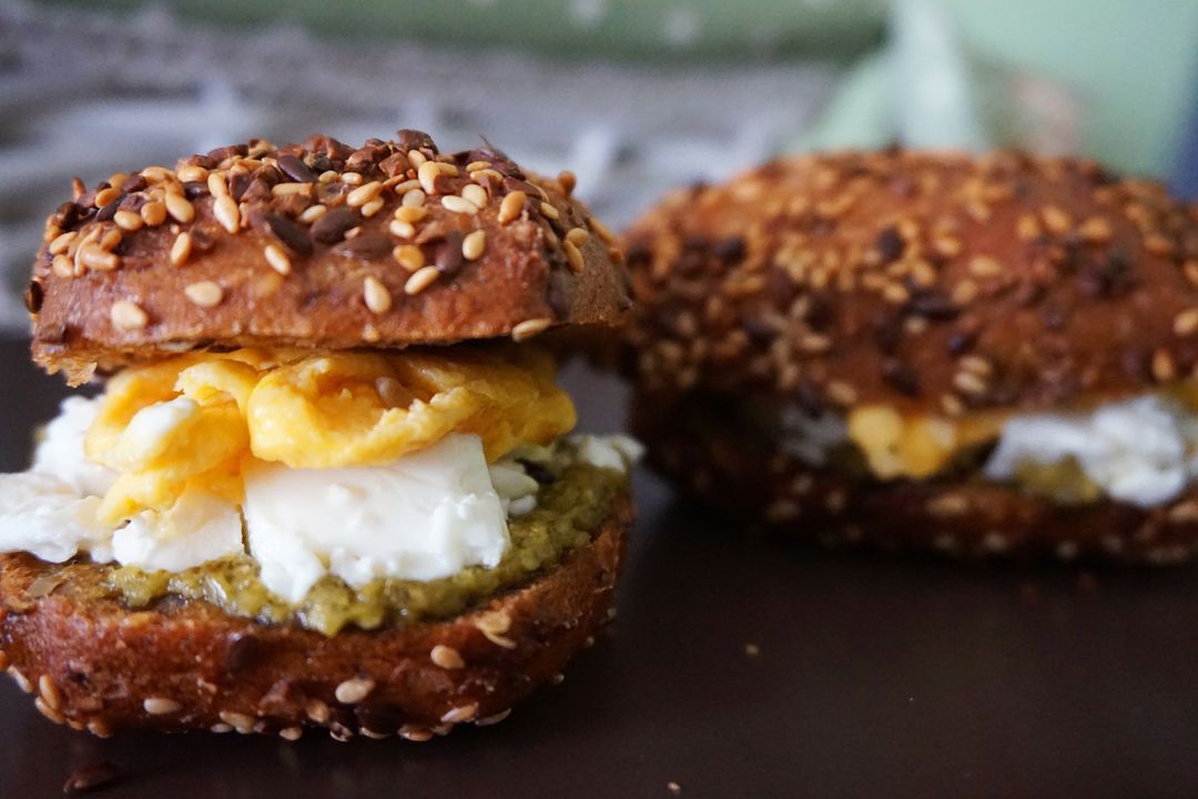 Toasted Sesame Bagel Sandwich with Scrambled Eggs, Cream Cheese and Pesto Spread