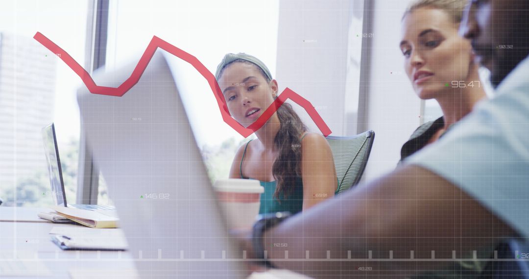 Diverse Team Analyzing Declining Graph in Office Setting
