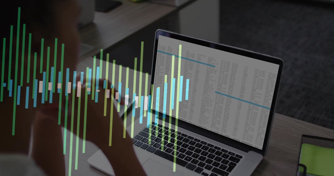 Blurred Office Desk and Businesswoman with Spreadsheet on Laptop