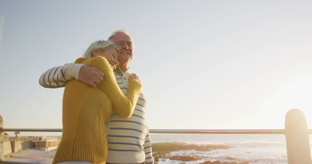Senior Couple Embracing at Seaside on Sunny Day
