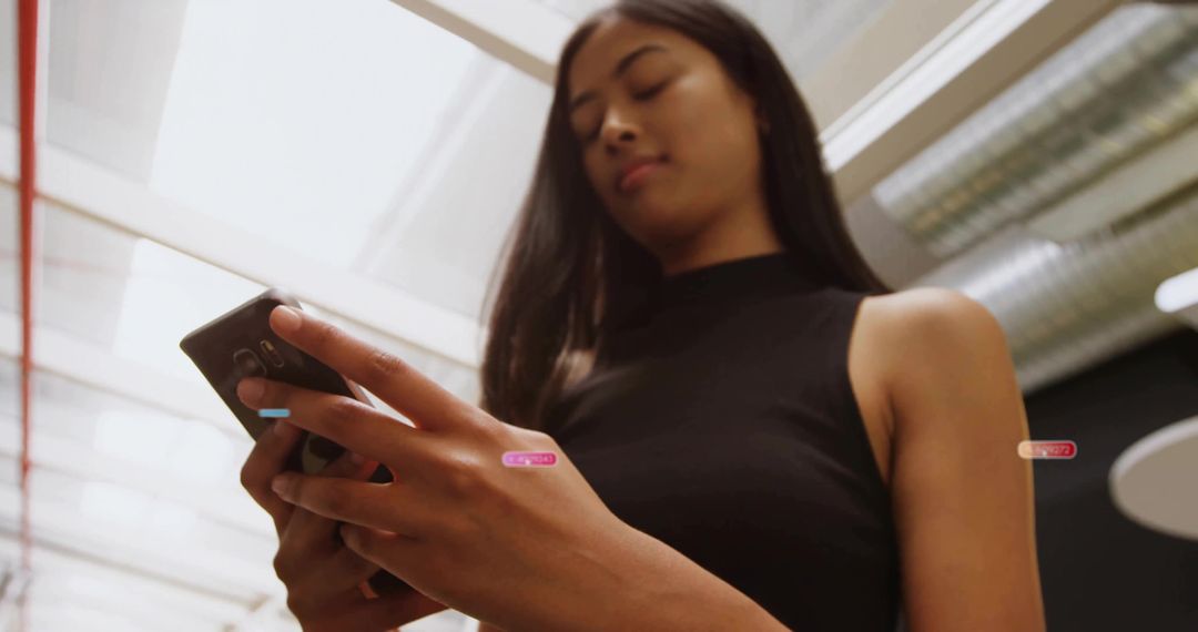 Modern Professional Woman Using Smartphone in Sleek Office Environment