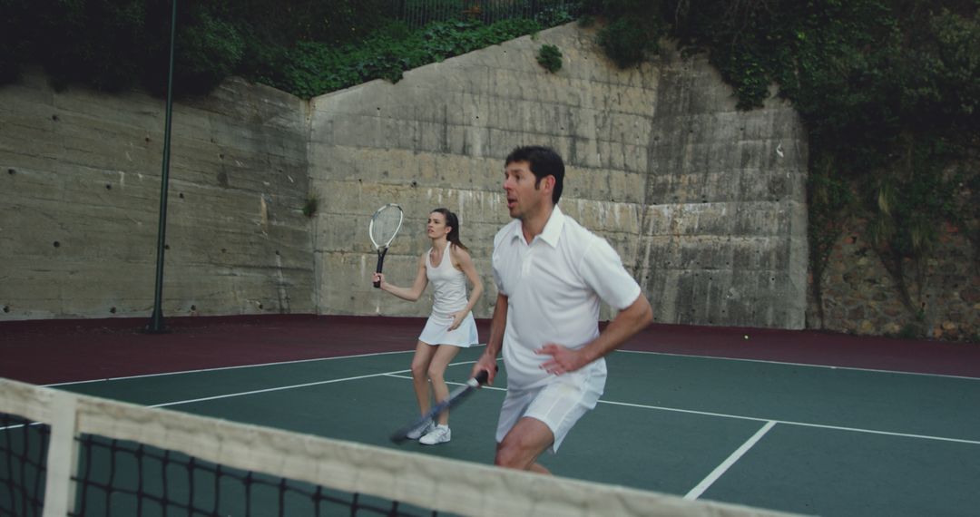 Mixed Doubles Tennis Match on Outdoor Court - Free Images, Stock Photos and Pictures on Pikwizard.com