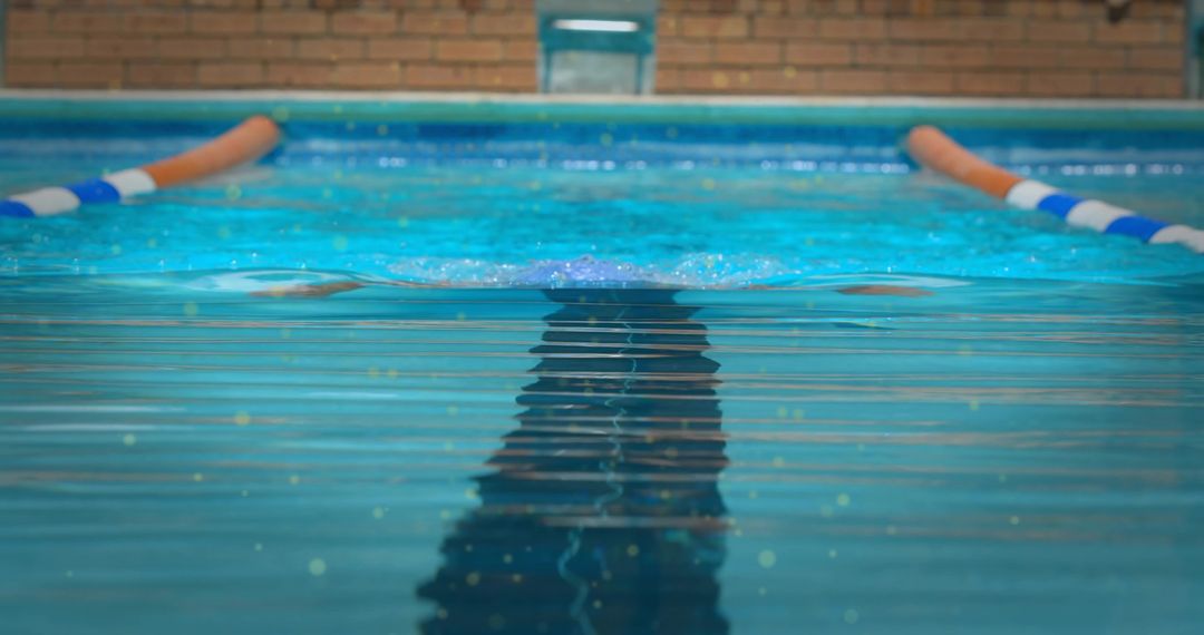 Minimalist Swimmer Gliding through Blue Lap Pool