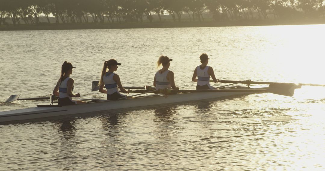 Team of Women Rowers in Boat at Sunrise on Tranquil Lake - Free Images, Stock Photos and Pictures on Pikwizard.com