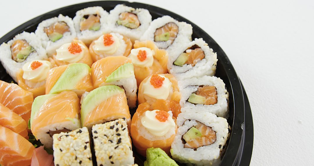 Assorted Sushi Platter with Rolls and Sashimi on Black Plate - Free Images, Stock Photos and Pictures on Pikwizard.com