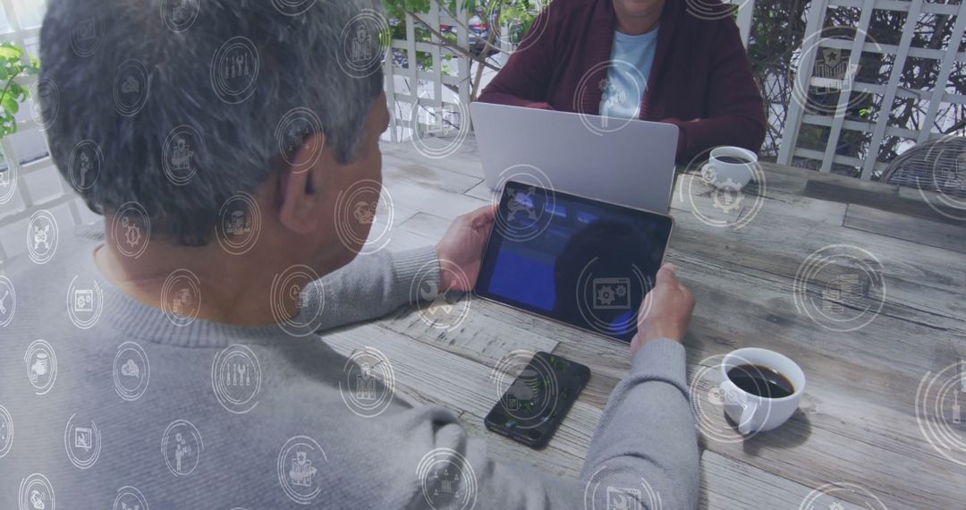Senior Couple Engaging with Digital Technology on Patio Deck