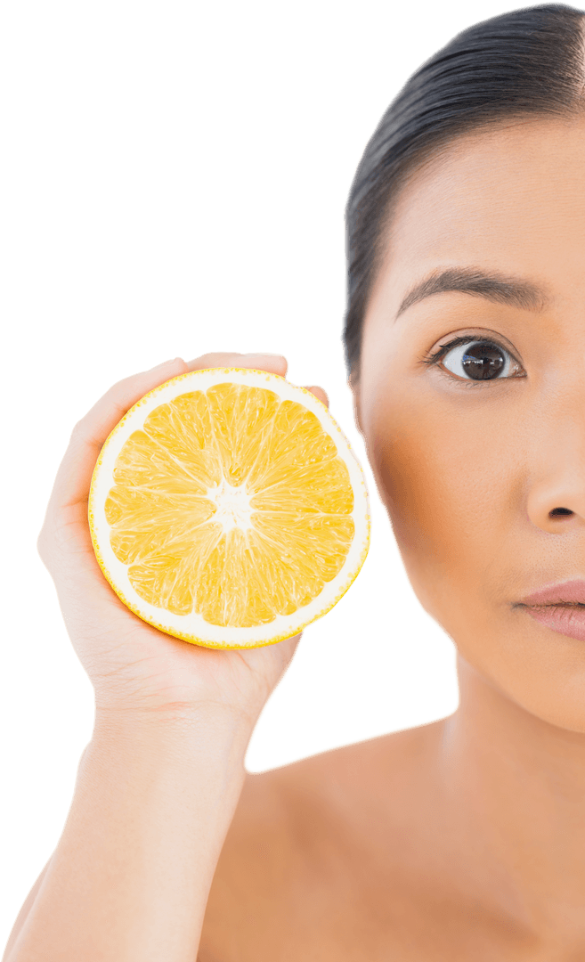 Half face Asian woman with orange half facing camera on white
