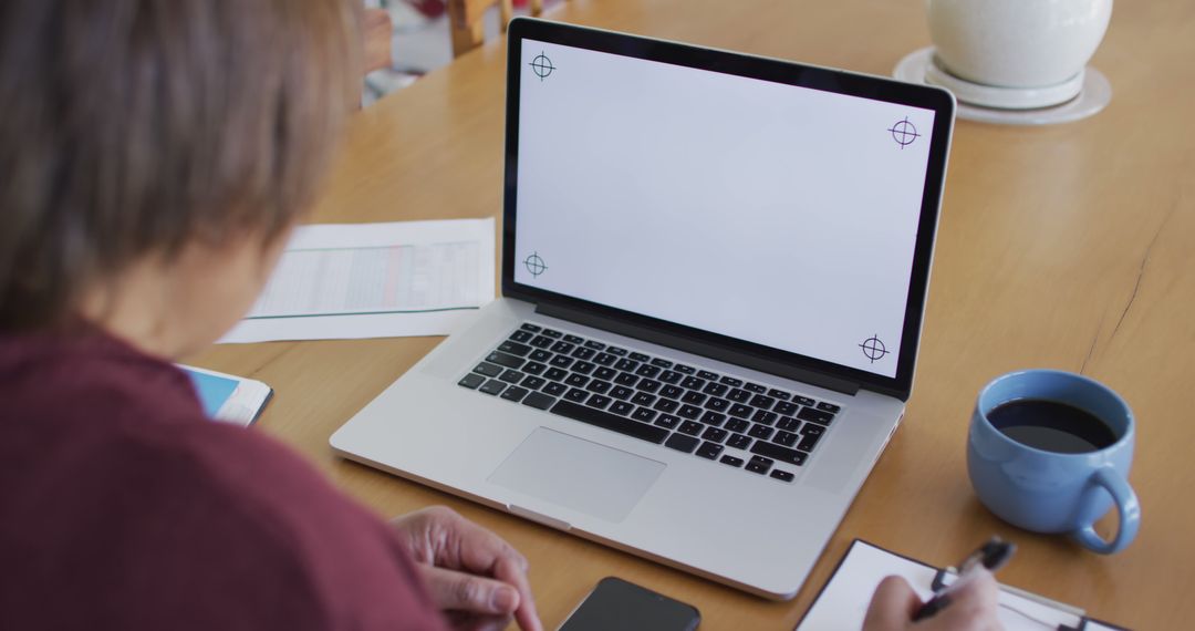 Senior Woman Using Laptop with Blank Screen