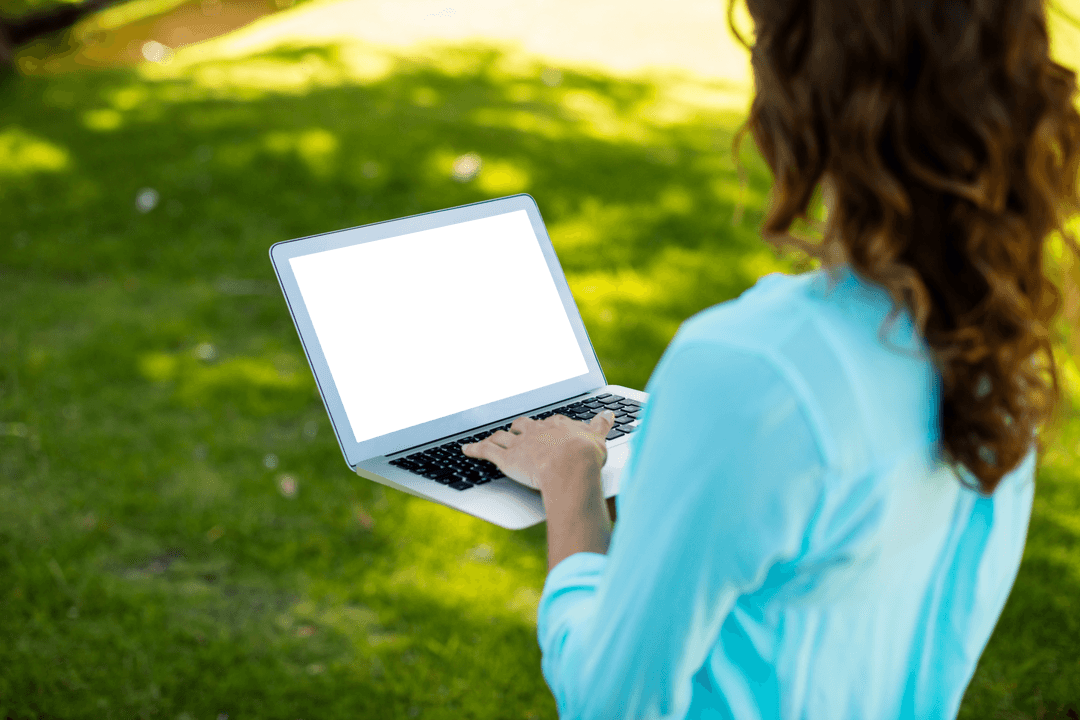 Woman in Park Using a Laptop with Transparent Screen