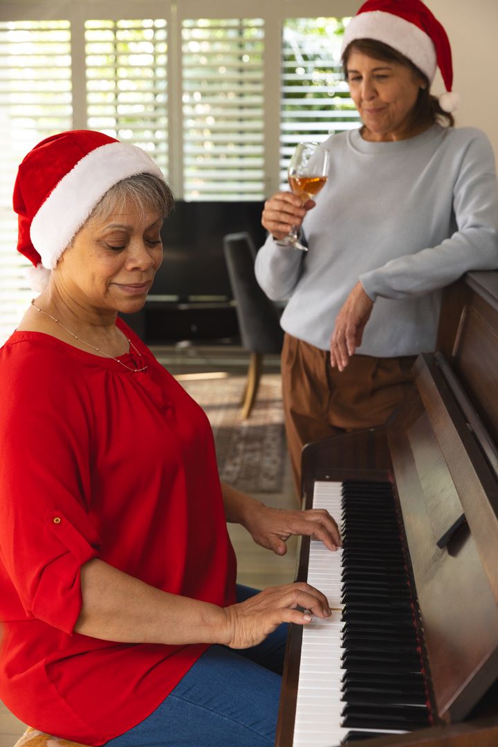 Senior Friends Celebrating Holidays with Piano and Wine at Home