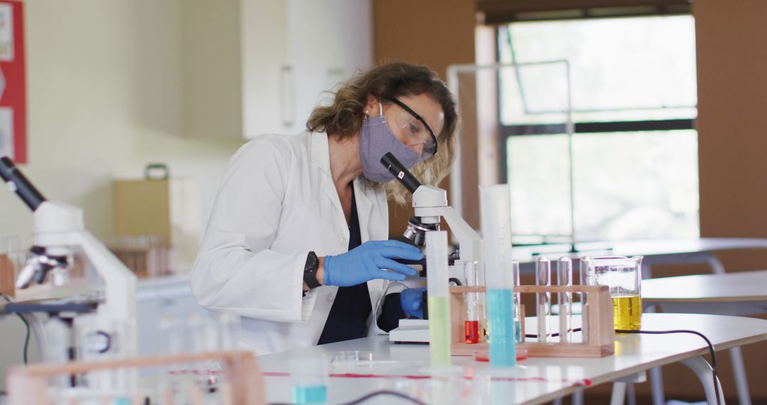 Female Scientist Using Microscope in Laboratory - Free Images, Stock Photos and Pictures on Pikwizard.com