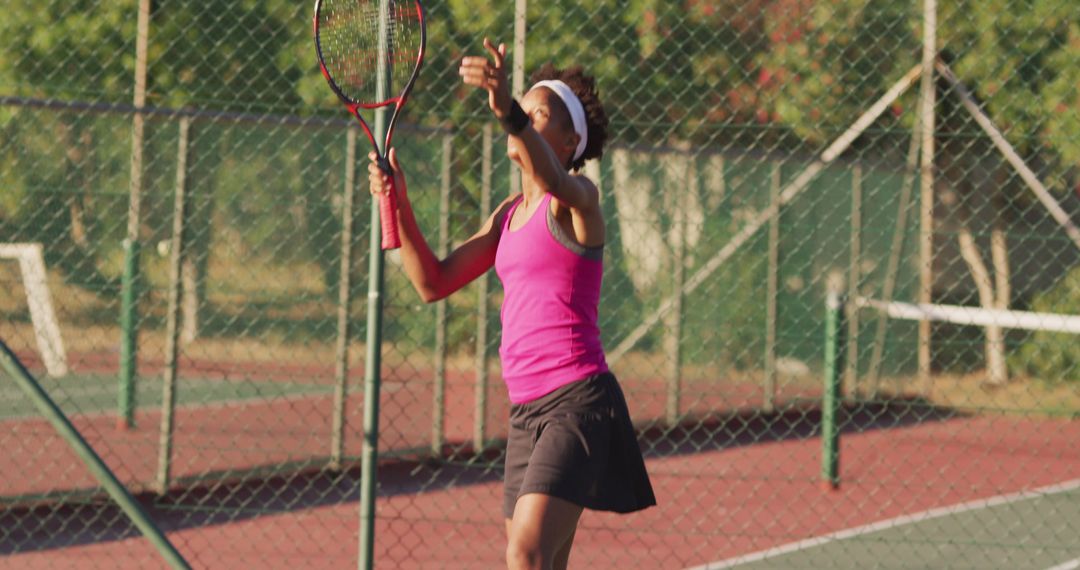 Woman Serving Tennis Ball on Outdoor Court During Daytime - Free Images, Stock Photos and Pictures on Pikwizard.com