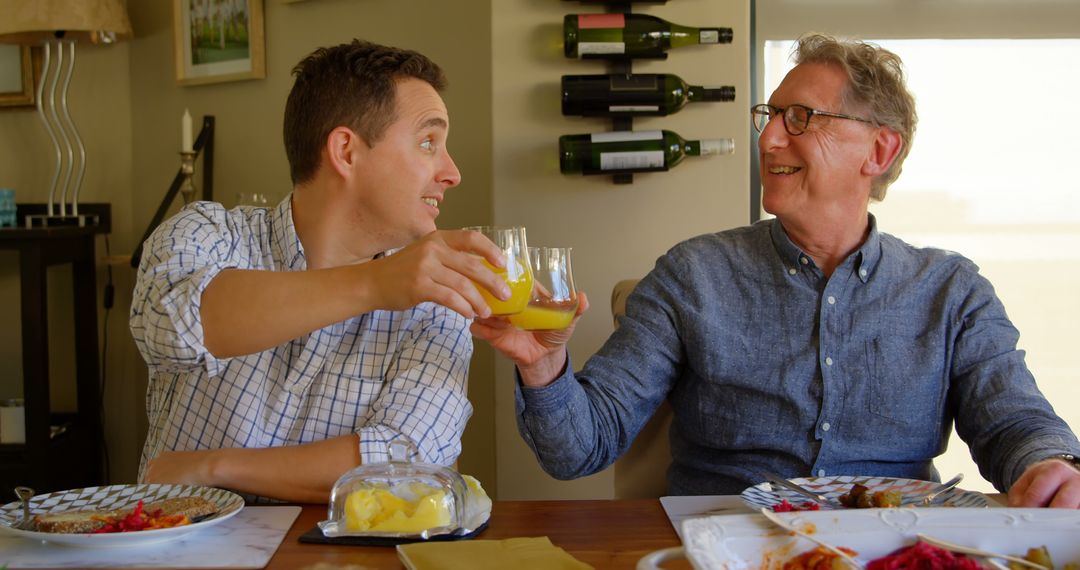 Father and Son Enjoying Brunch Together with Juice Toast