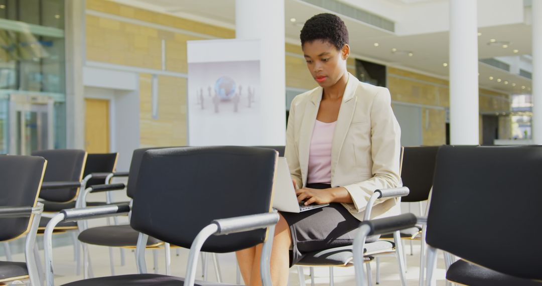 Businesswoman Using Laptop During Seminar Presentation