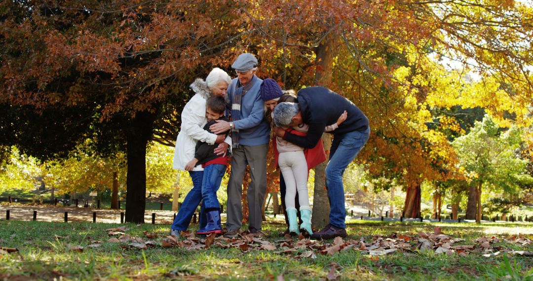 Multigenerational Family Embracing in Autumn Park - Free Images, Stock Photos and Pictures on Pikwizard.com