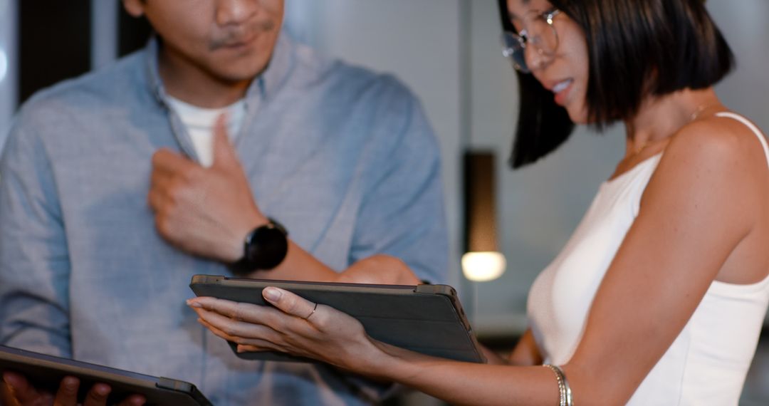 Diverse Professionals Collaborating with Digital Tablets in Office