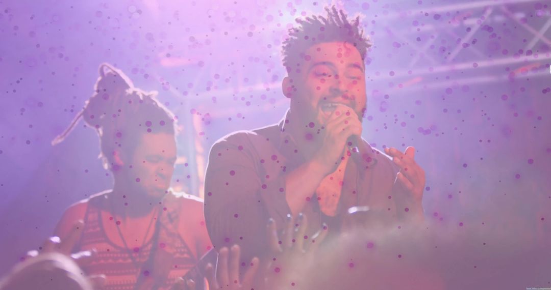 Energetic Singer Performing Live on Stage with Vibrant Haze