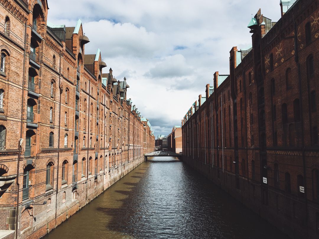 Historic Brick Warehouses by Canal in Hamburg, Germany - Free Images, Stock Photos and Pictures on Pikwizard.com