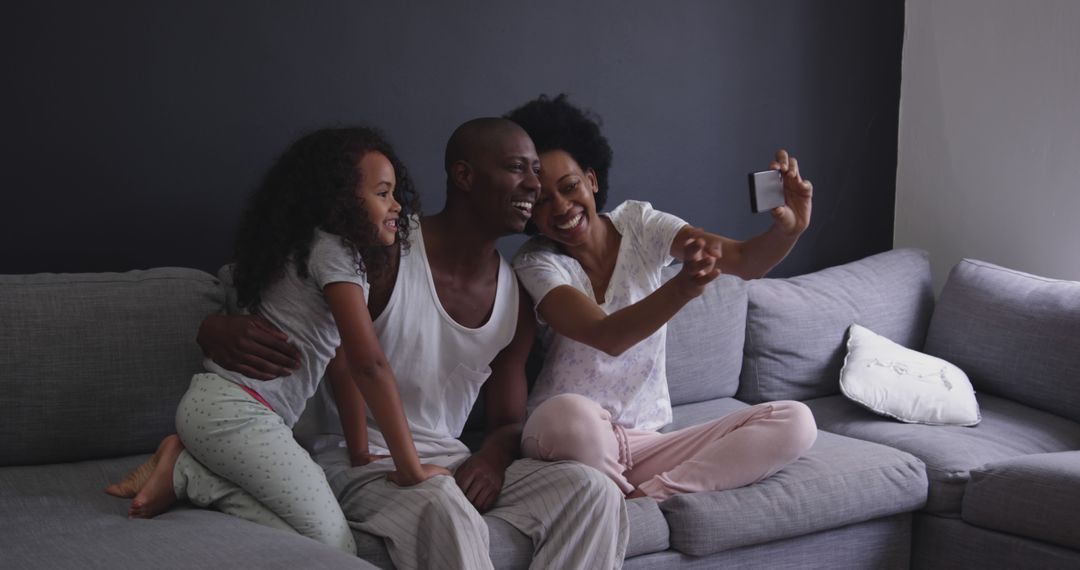 Happy family taking selfie on cozy living room sofa - Free Images, Stock Photos and Pictures on Pikwizard.com