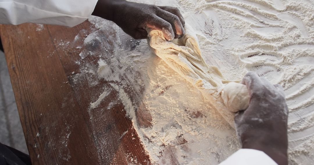 Hands Kneading Dough on Floured Wooden Surface - Free Images, Stock Photos and Pictures on Pikwizard.com