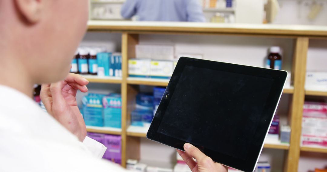 Pharmacist using digital tablet in pharmacy - Free Images, Stock Photos and Pictures on Pikwizard.com