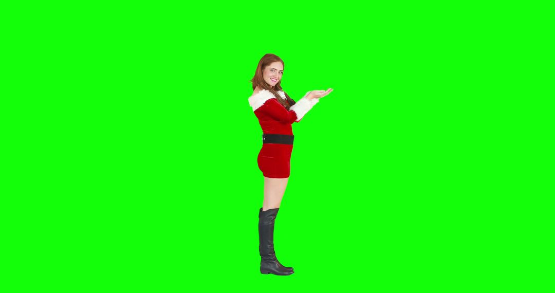 Cheerful Santa’s Helper in Red Outfit Presenting on Green Screen - Free Images, Stock Photos and Pictures on Pikwizard.com