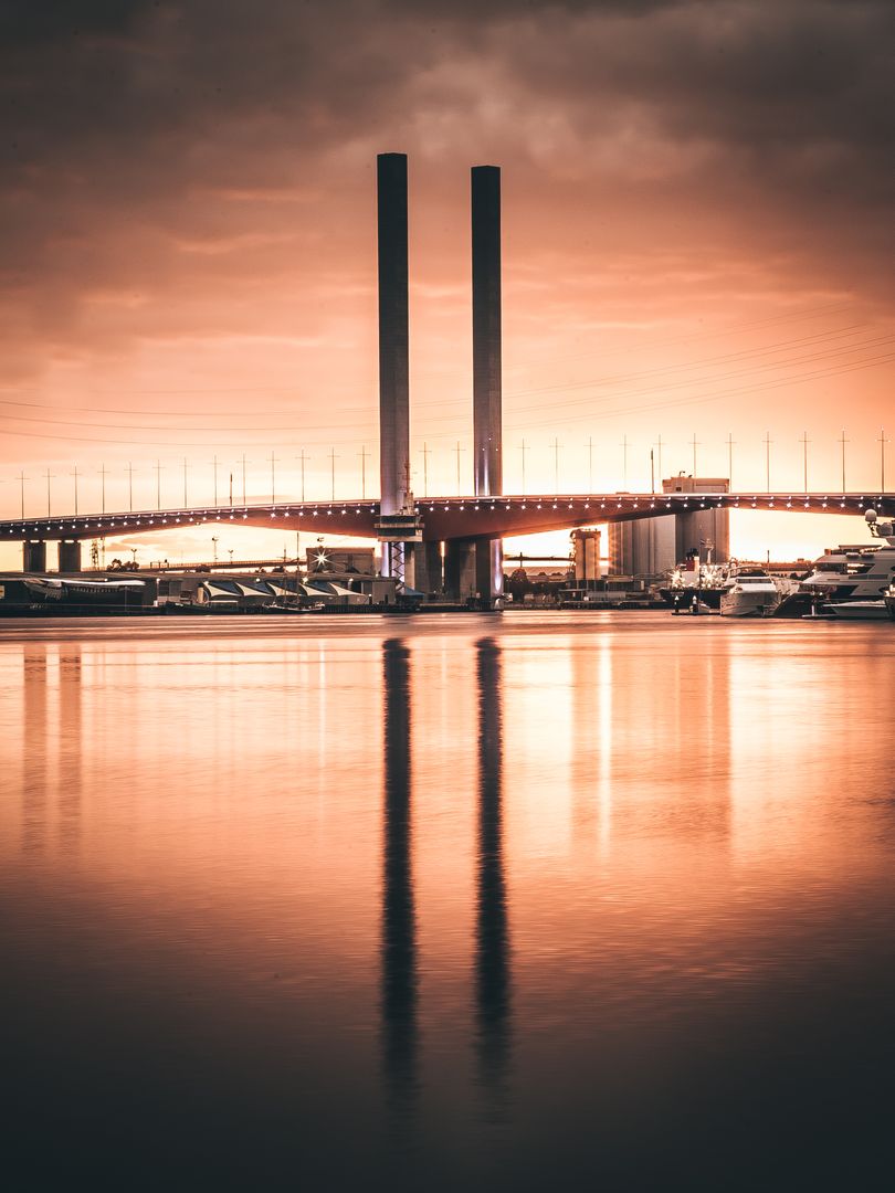 Sunset Reflection of Bolte Bridge Towers on Water in Melbourne - Free Images, Stock Photos and Pictures on Pikwizard.com