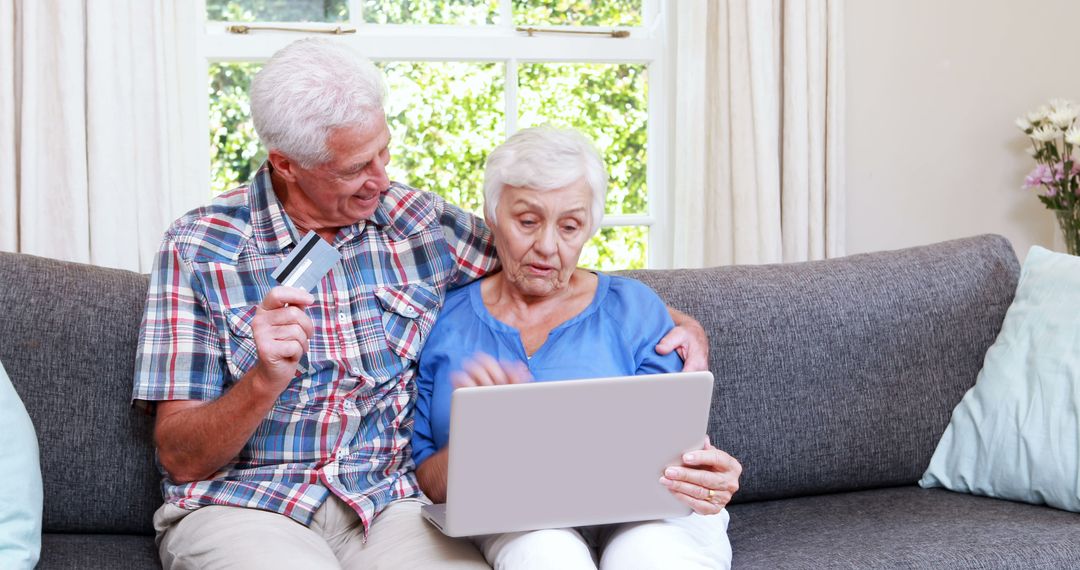 Senior Couple Online Shopping with Laptop on Couch - Free Images, Stock Photos and Pictures on Pikwizard.com