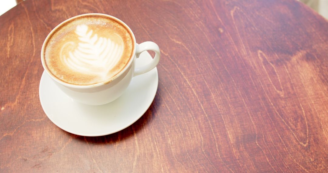 Cappuccino with Latte Art on Rustic Wood Table