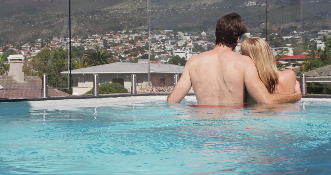 Romantic Couple Relaxing in Swimming Pool with Scenic Mountain View - Free Images, Stock Photos and Pictures on Pikwizard.com